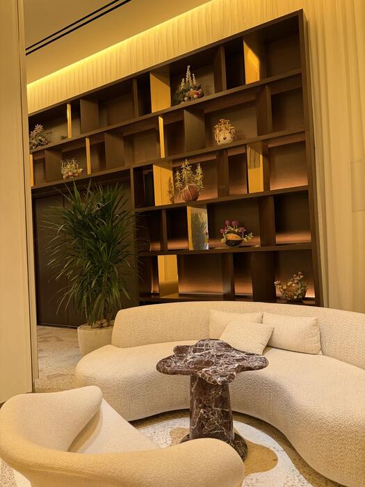 Reading nook with curved sofa and lit display shelving